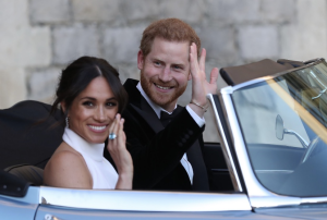 Photo Caption: Prince Harry and Meghan Markle after the celebration of their wedding. Photograph: REX/Shutterstock